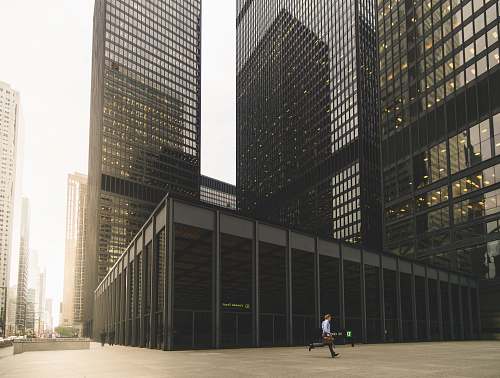 financial district man walking along high-rise building toronto